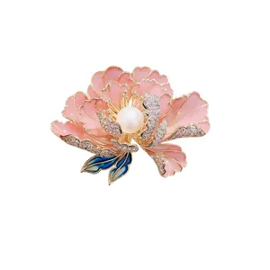 Detailed macro view of an elegant pink peony flower brooch with center pearl and crystals
