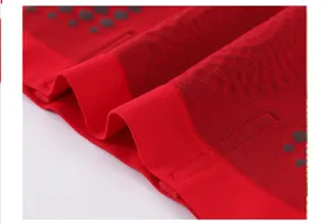 Close-up detail of red seamless high-waist shaping underwear fabric texture with silicone dots.