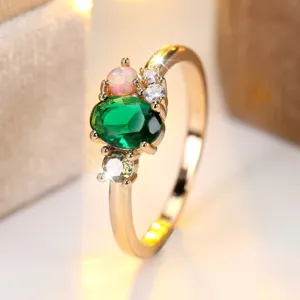 Elegant gold ring featuring oval green gemstone and synthetic opal inlay for women