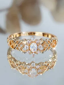 Detailed view of vintage gold plated filigree ring with oval moonstone and CZ stones