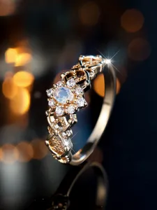 Detailed macro view of a gold-plated filigree ring with oval moonstone and zircons