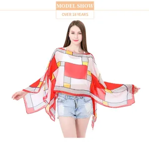 Model wearing a summer sun protection shawl with red geometric Mondrian pattern design