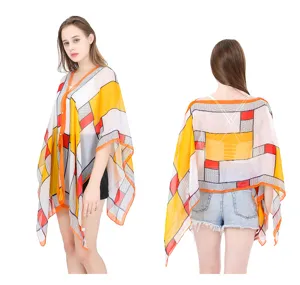 Front and back view of a summer geometric plaid sunscreen shawl with button detail