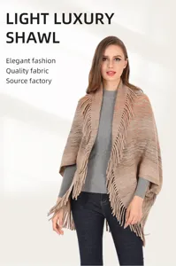 Elegant knitted shawl poncho with fringe tassels for stylish autumn winter warmth.
