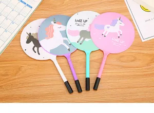 Detailed view of four colorful unicorn-themed fan pens on a wooden desk for students