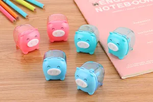 Close-up of cute pink and blue pig-shaped manual pencil sharpeners on a wooden desk