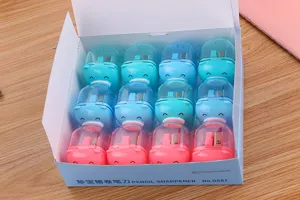 A box containing 12 colorful and cute pig-shaped manual pencil sharpeners for school kids.