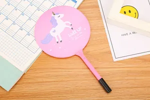 Close-up of a pink fan-shaped ballpoint pen with cartoon unicorn illustration