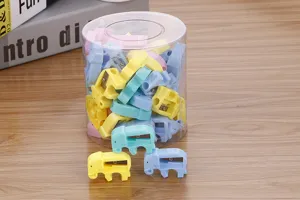 Detailed macro view of cute candy-colored elephant pencil sharpeners in clear storage tub