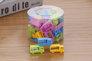 Detail view of colorful car-shaped pencil sharpeners in a clear round canister