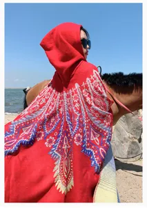 Elegant bohemian style red hooded poncho featuring ethnic knit patterns for outdoor travel