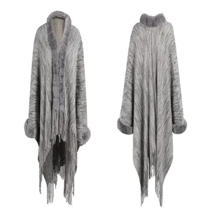 Elegant gray knitted poncho with faux fur collar and tassel trim, front and back view