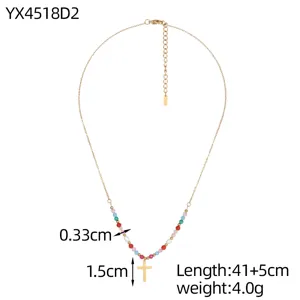 Detailed view of handmade colorful beaded necklace with gold-tone cross pendant