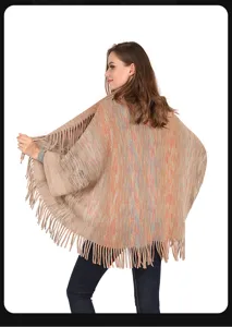 Back view of women's colorful knitted poncho shawl featuring bohemian fringe details