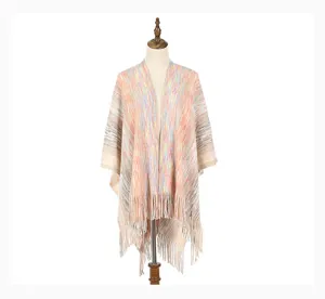 Detailed view of a warm multi-colored striped knitted shawl with elegant fringe detail.