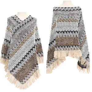 Macro view of ethnic knitted poncho featuring chevron patterns and fringe detail