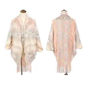Women's multi-color knitted poncho shawl with fringe detail shown from front and back