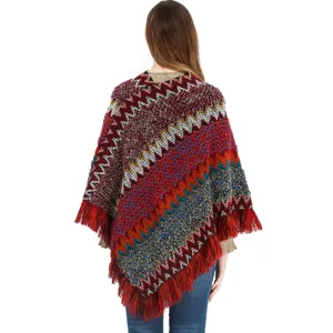 Ethnic style knitted poncho for women with colorful zigzag pattern and fringe detail