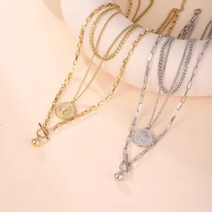 Close-up of retro triple-layered coin necklace in gold and silver finish