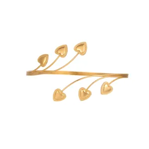 Detailed view of an elegant gold arm cuff with delicate heart-shaped accents.