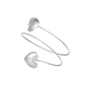 Detailed view of silver heart-shaped arm cuff featuring a polished finish and spiral design