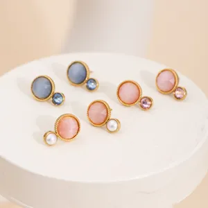Detail view of multi-color cat eye stone stud earrings with pearl and crystal accents