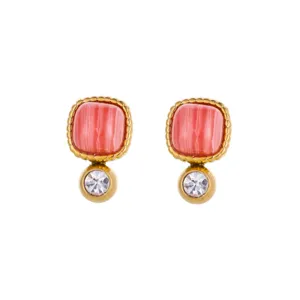 Detail view of square sugar-cube earrings with pink stone and small clear crystal