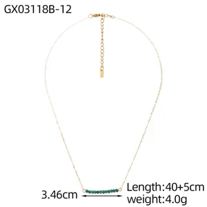 Macro view of gold thin chain necklace with green natural stones and 40+5cm length