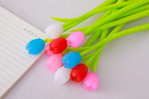 Close-up of colorful tulip flower-shaped gel pens on a desk with a notebook