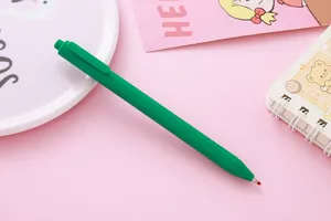 Close-up of a green Morandi retractable gel pen on a cute pink stationery background.