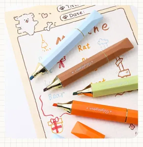 Close-up of colorful diamond-shaped highlighters on a cute decorative grid notebook