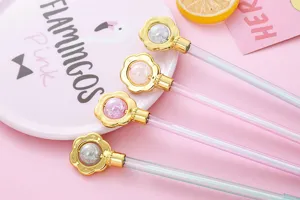 Detail view of cute flower-shaped gel pen caps with shimmering crystal beads inside