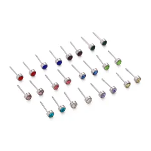 Detailed close-up showing an array of tiny steel stud earrings with colorful birthstones