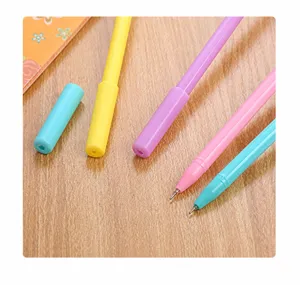 Detailed close-up showing macaron colored gel pen tips and caps on a wooden background.