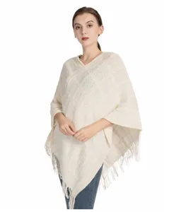 Beiger Strick-Poncho aus Chenille mit Fransen, am Modell für den Herbst-Winter-Stil.