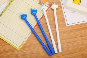 Detail view of cute cartoon whale toppers on blue and white creative neutral pens