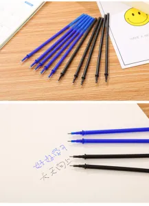 Close-up of blue and black thermal erasable pen refills showing writing effect on paper.