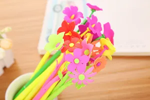 Close-up detail of vibrant soft rubber flower-shaped toppers on various colorful gel pens