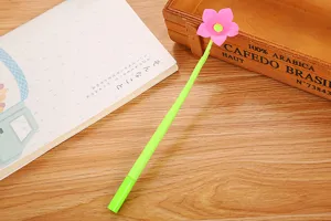 Close-up of a creative green gel pen featuring a vibrant pink soft rubber flower topper design