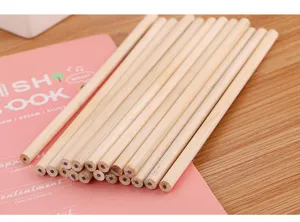 Detailed view of unsharpened natural wood pencils bundle on a pink notebook and desk.