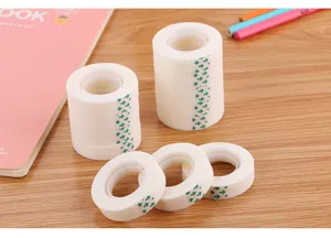 Multiple rolls of matte invisible tape on wooden desk for office and creative craft