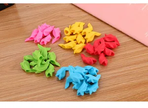 Detailed view of colorful fish-shaped silicone pencil grips for kids