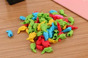 Close-up macro view showing a pile of colorful fish-shaped silicone pencil grips for kids