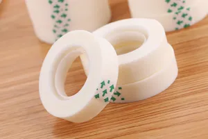 Close-up of matte invisible tape rolls for office and craft on wooden background