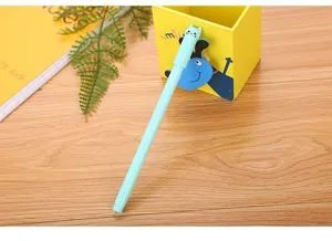 Macro detail shot of a light blue gel pen with a cute cartoon cat cap on a wooden desk