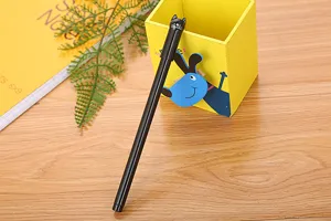 Close-up of a cute black cartoon cat head cap on a sleek office neutral gel pen