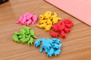 Detailed view of colorful fish-shaped soft rubber pencil grips for children
