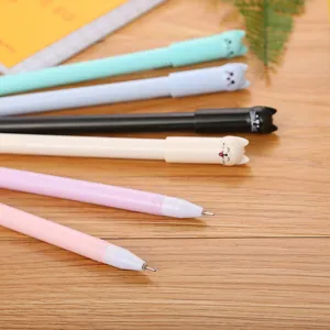 Set of creative cute cartoon cat cap gel pens in various pastel colors on wooden surface