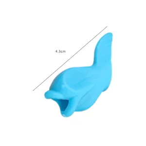 Blue dolphin-shaped soft silicone pencil grip corrector for kids' writing posture, 4.3cm long.