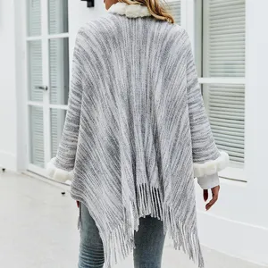 Grey knitted warm poncho featuring soft faux fur collar and fringe hem for women
